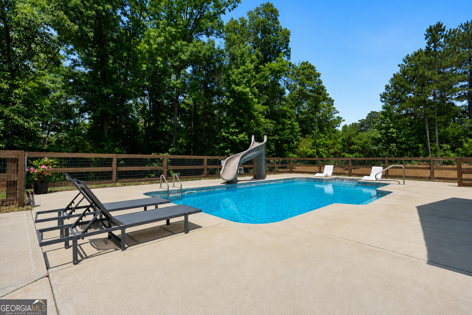 89 Claire Road Forsyth, GA 31029 - Photo 33 of 40 a view of a swimming pool with a patio and yard