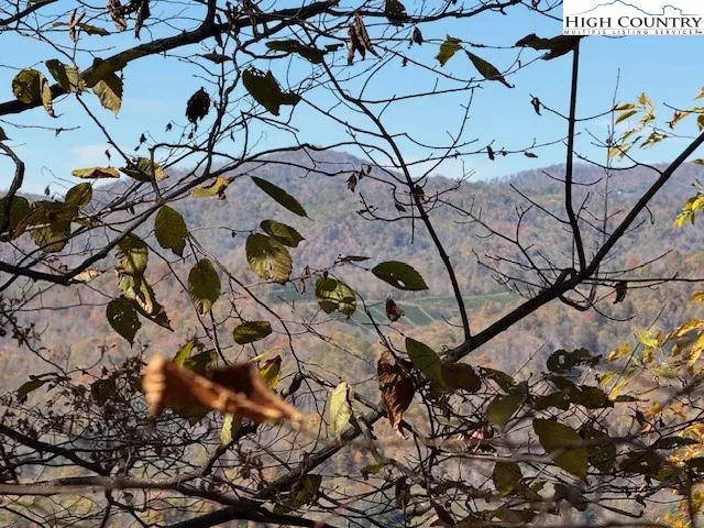 a view of mountain with a field