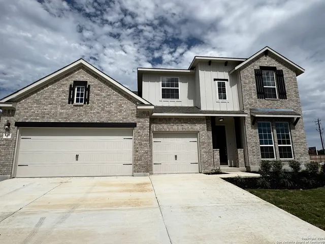 a front view of a house with garage