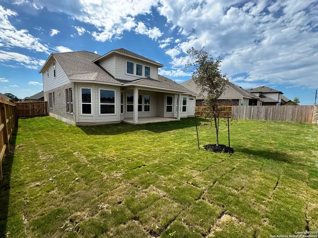 a front view of a house with a yard table and chairs