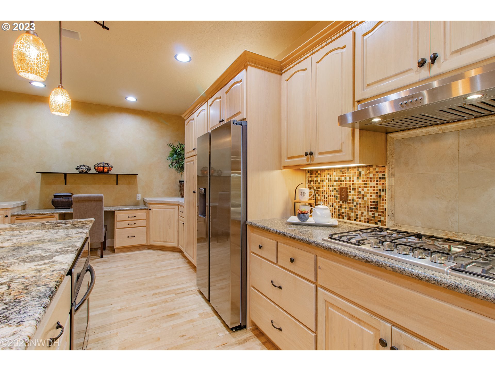 2983 Grand Cayman Drive Eugene, OR 97408 - Photo 13 of 43 a kitchen with kitchen island granite countertop cabinets and refrigerator
