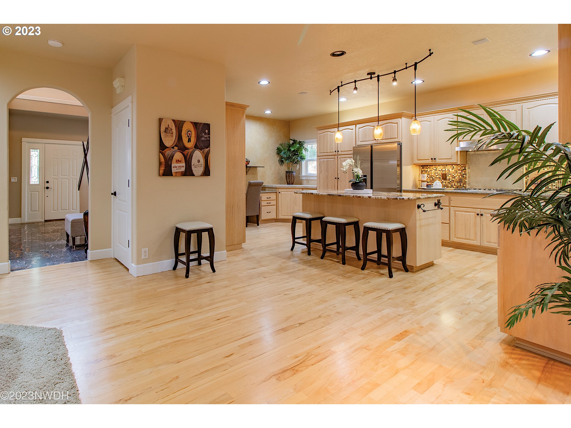 2983 Grand Cayman Drive Eugene, OR 97408 - Photo 14 of 43 a view of a living room and kitchen with furniture and a floor to ceiling window
