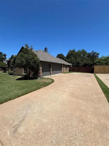 a view of a house with backyard and porch