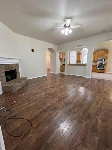 a view of an empty room with window and fireplace