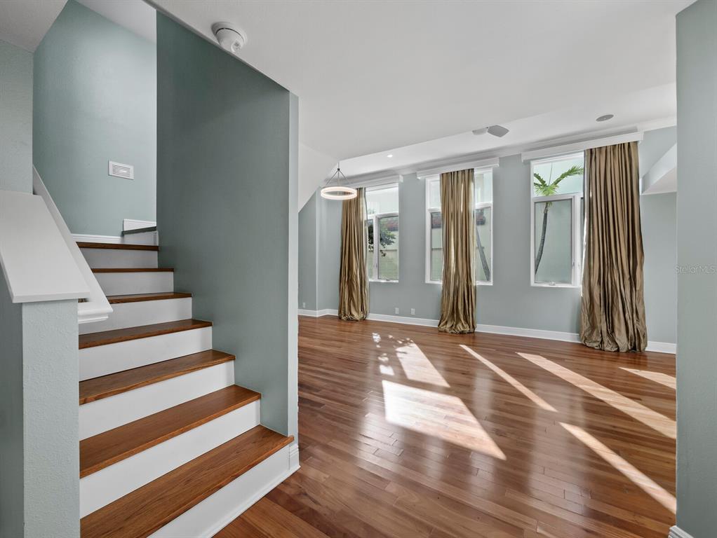 200 Cocoanut Avenue, Unit 7 Sarasota, FL 34236 - Photo 12 of 63 a view of a livingroom with wooden floor and stairs