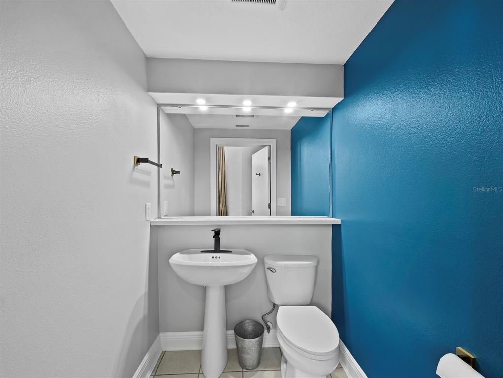 200 Cocoanut Avenue, Unit 7 Sarasota, FL 34236 - Photo 17 of 63 a bathroom with a sink toilet and mirror