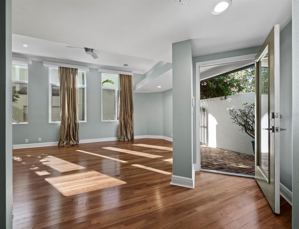 200 Cocoanut Avenue, Unit 7 Sarasota, FL 34236 - Photo 10 of 63 a view of a room with wooden floor and door