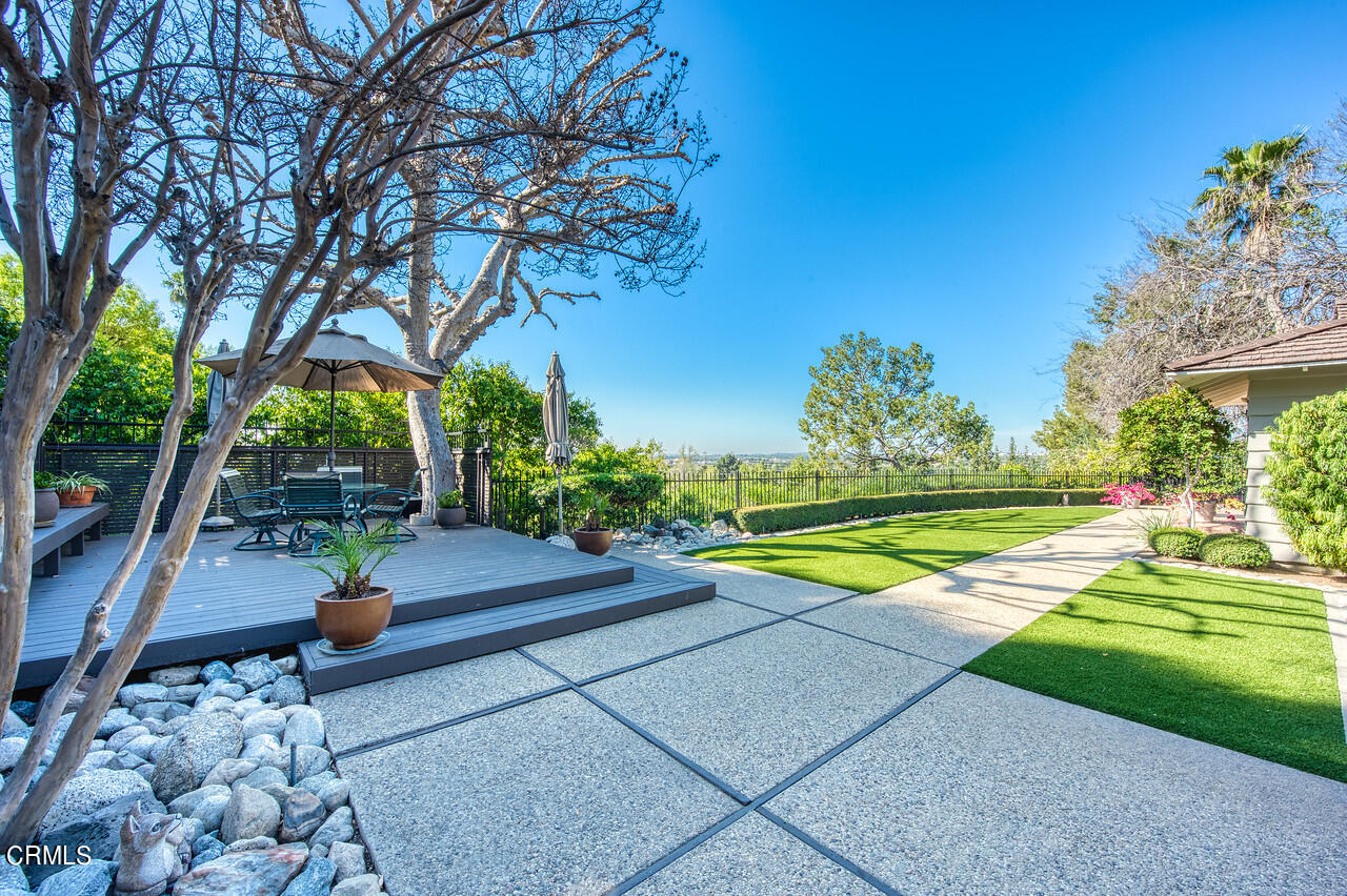 a view of yard with swimming pool and green space