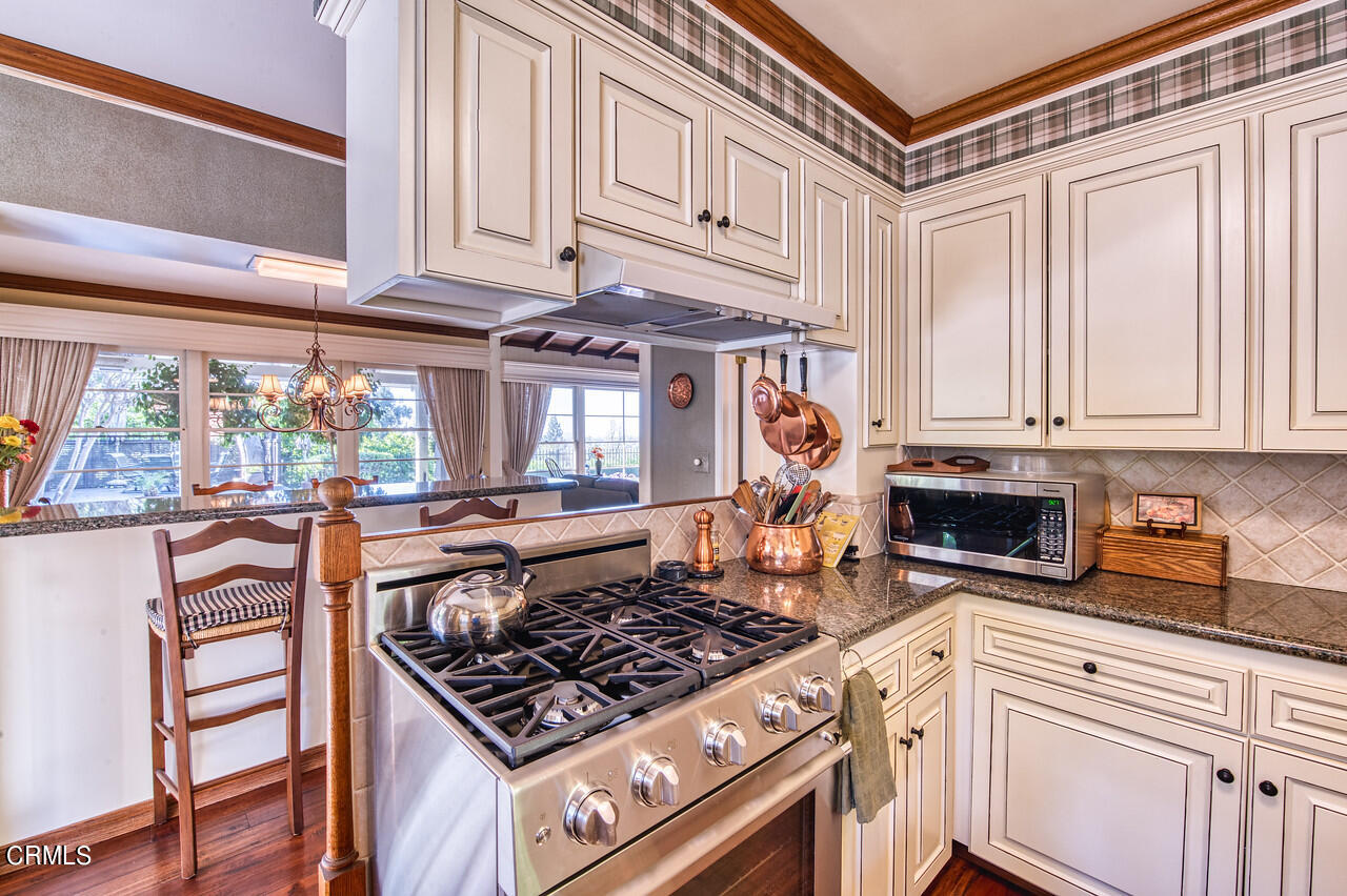 3320 Calvert Road Pasadena, CA 91107 - Photo 14 of 27 a kitchen with stainless steel appliances granite countertop a stove and a refrigerator