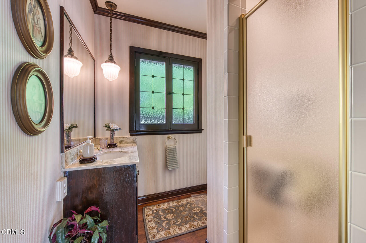 3320 Calvert Road Pasadena, CA 91107 - Photo 17 of 27 a bathroom with a mirror and a sink