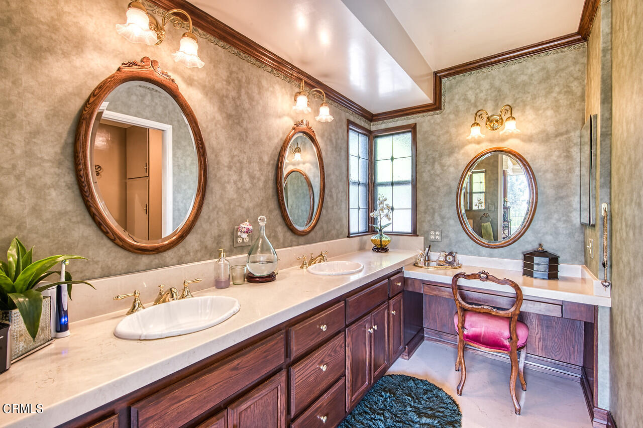 3320 Calvert Road Pasadena, CA 91107 - Photo 21 of 27 a bathroom with a granite countertop toilet a double vanity sink and a mirror