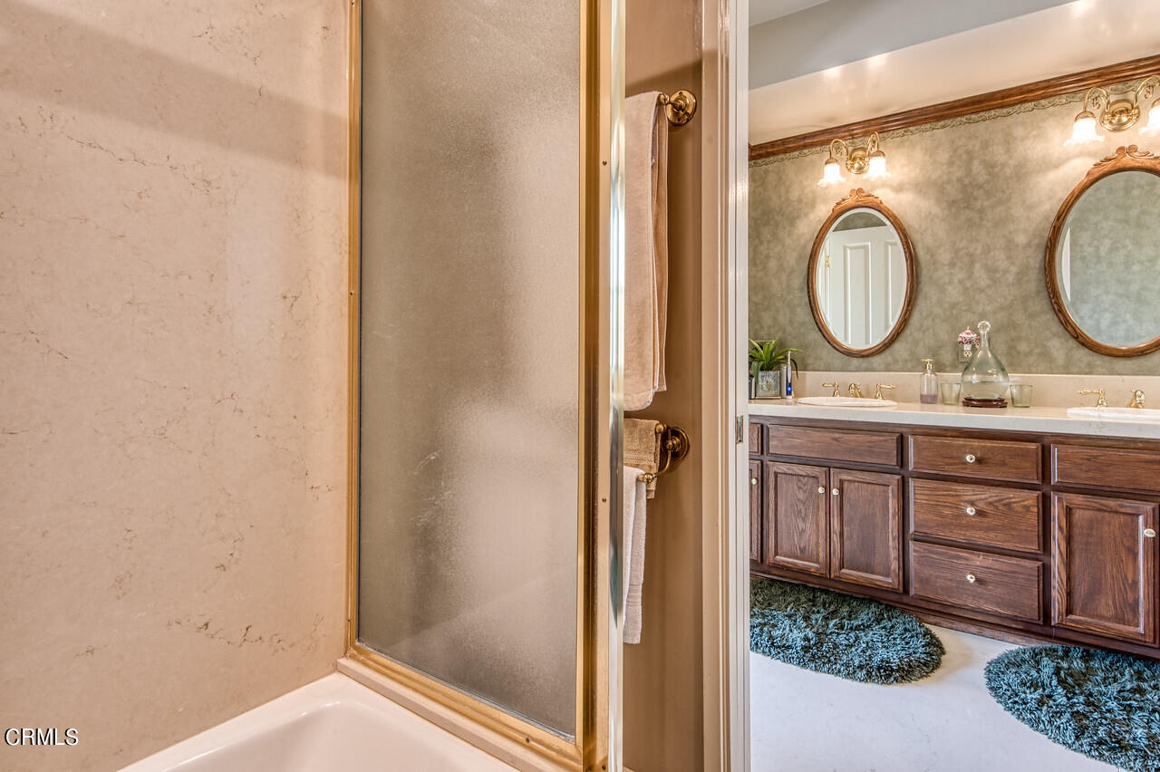 3320 Calvert Road Pasadena, CA 91107 - Photo 22 of 27 a bathroom with a granite countertop sink mirror and vanity