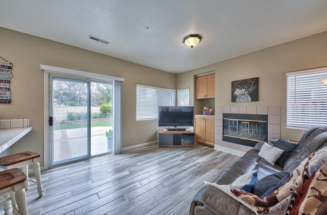 18067 Stonehaven Salinas, CA 93908 - Photo 12 of 33 a living room with furniture a fireplace and a large window