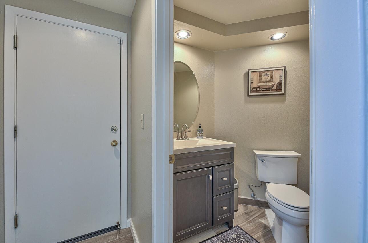 18067 Stonehaven Salinas, CA 93908 - Photo 14 of 33 a bathroom with a granite countertop toilet a sink and a mirror