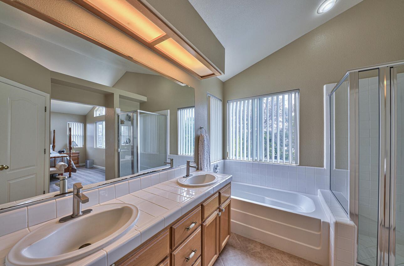 18067 Stonehaven Salinas, CA 93908 - Photo 22 of 33 a bathroom with a tub sink and mirror
