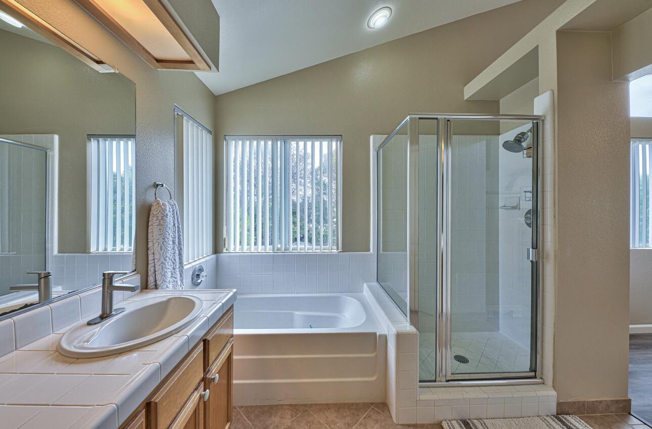 18067 Stonehaven Salinas, CA 93908 - Photo 23 of 33 a bathroom with a granite countertop sink and a mirror