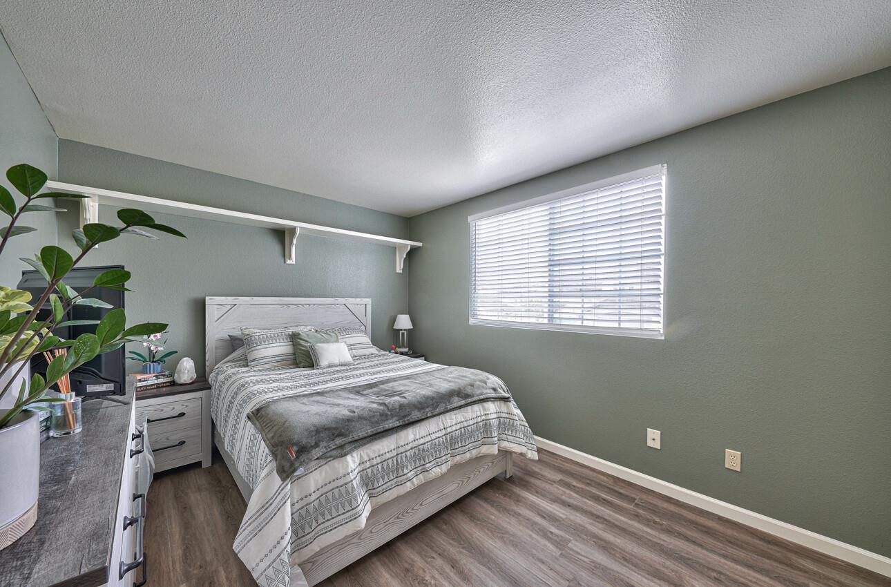 18067 Stonehaven Salinas, CA 93908 - Photo 25 of 33 a bedroom with a bed and a potted plant