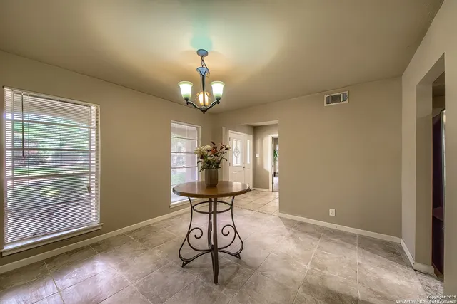 a view of a hallway with chandelier