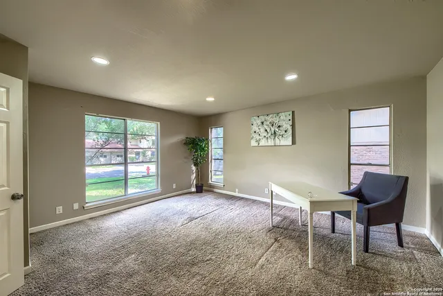 a view of workspace with furniture and window