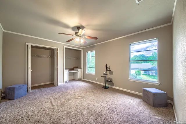 a view of livingroom with window chandelier fan and windows