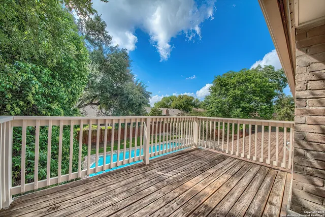 a view of balcony with wooden floor and fence