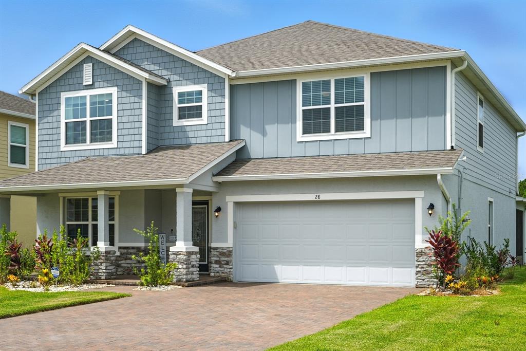 a front view of a house with a yard and garage