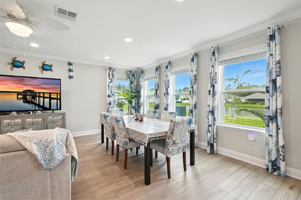 28 Ridge Road Palm Coast, FL 32137 - Photo 17 of 57 a view of a dining room with furniture window and wooden floor