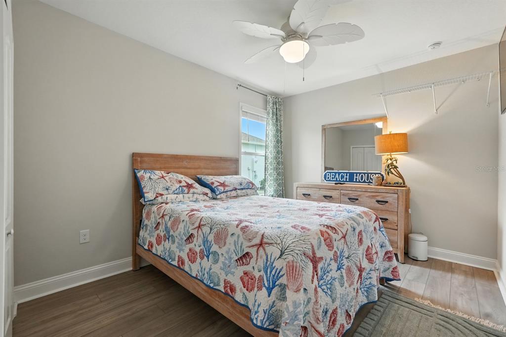 28 Ridge Road Palm Coast, FL 32137 - Photo 18 of 57 a bedroom with a bed and a chandelier