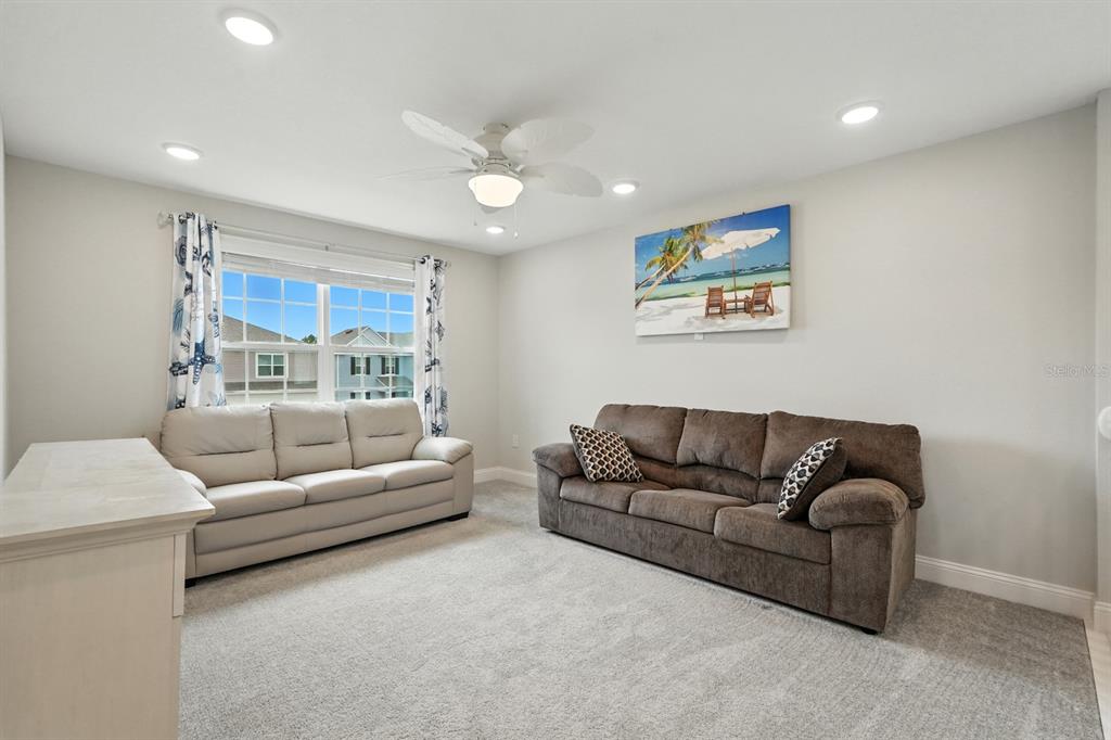 28 Ridge Road Palm Coast, FL 32137 - Photo 25 of 57 a living room with furniture and a large window