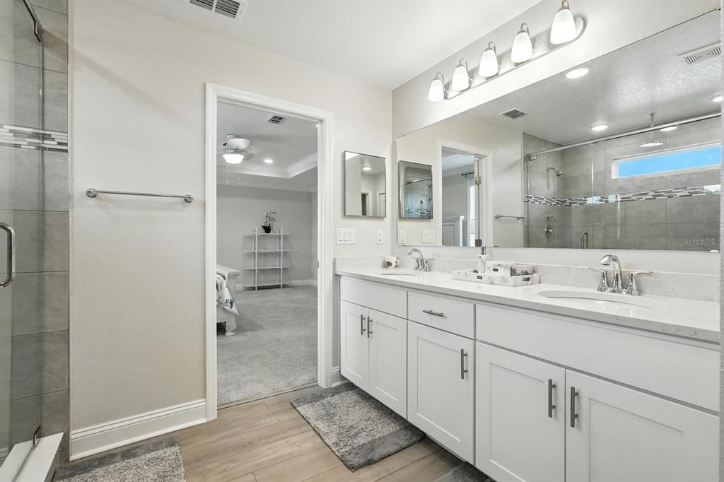 28 Ridge Road Palm Coast, FL 32137 - Photo 34 of 57 a bathroom with a double vanity sink mirror and shower