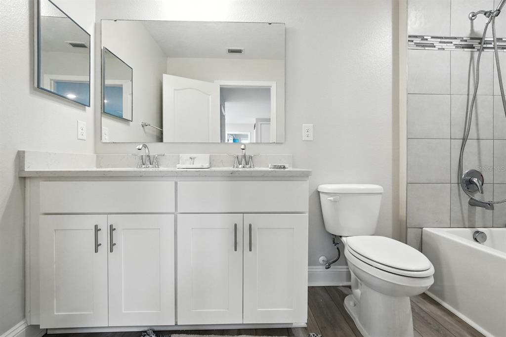 28 Ridge Road Palm Coast, FL 32137 - Photo 38 of 57 a bathroom with a sink a toilet and shower