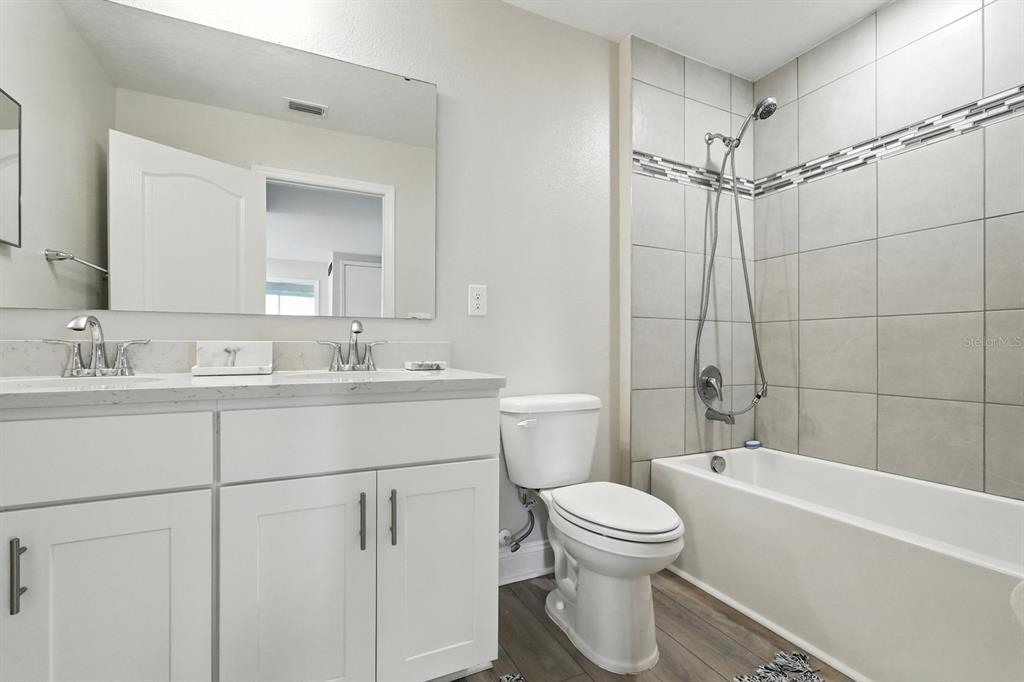 28 Ridge Road Palm Coast, FL 32137 - Photo 39 of 57 a bathroom with a sink a toilet and a bathtub