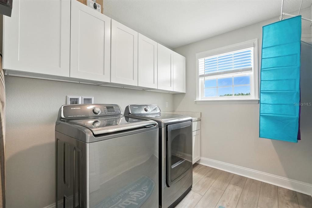 28 Ridge Road Palm Coast, FL 32137 - Photo 40 of 57 a utility room with sink dryer and washer