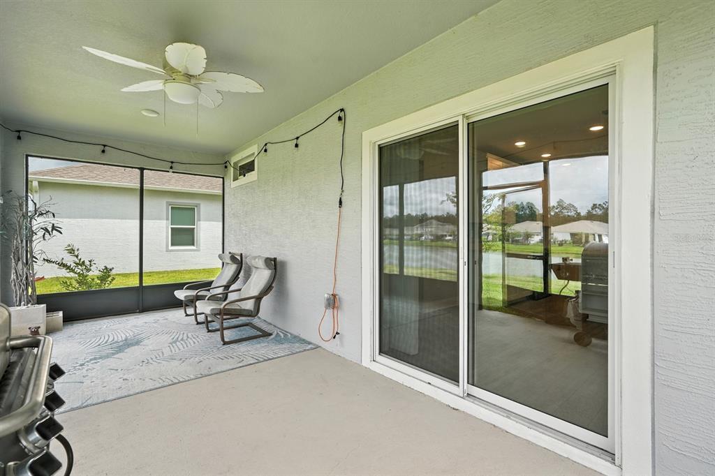 28 Ridge Road Palm Coast, FL 32137 - Photo 42 of 57 a living room with glass door and furniture