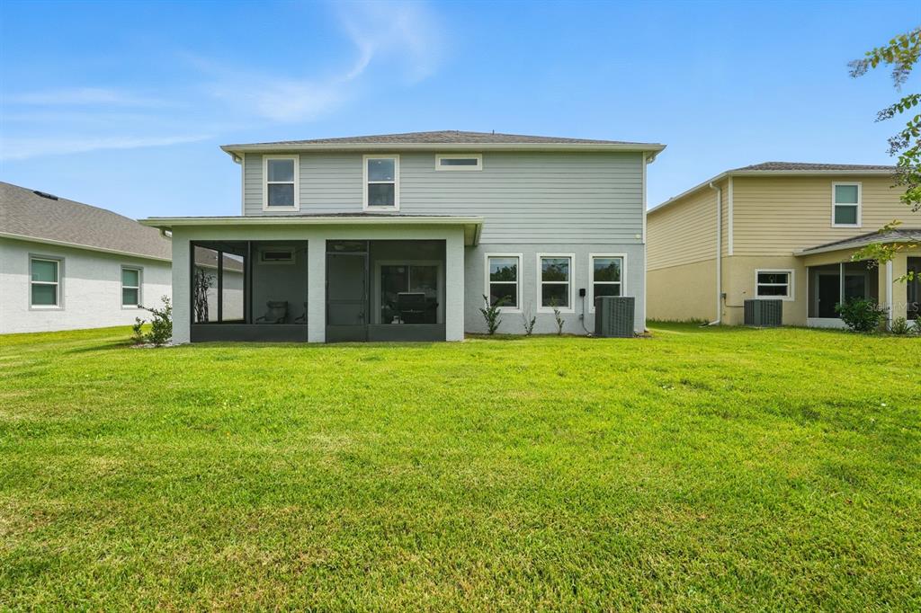 28 Ridge Road Palm Coast, FL 32137 - Photo 46 of 57 a front view of a house with a garden