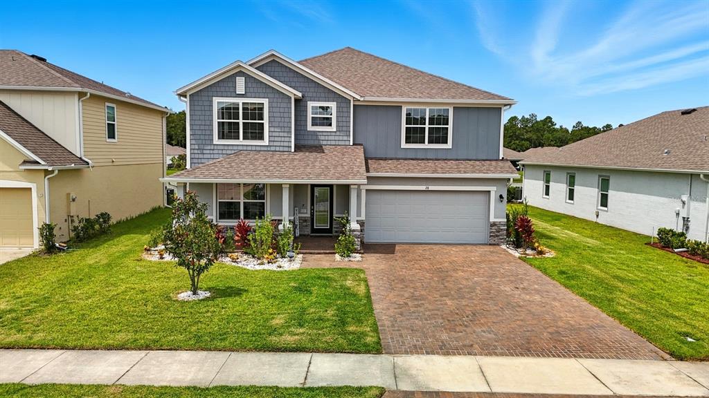 28 Ridge Road Palm Coast, FL 32137 - Photo 49 of 57 a front view of a house with a yard