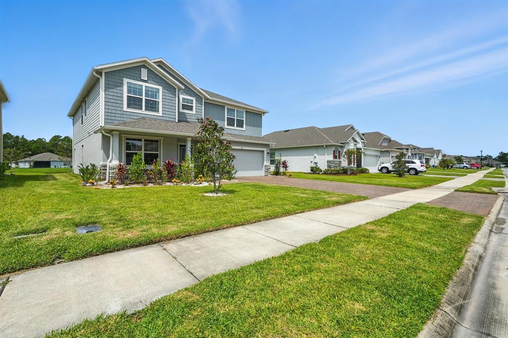 28 Ridge Road Palm Coast, FL 32137 - Photo 51 of 57 a front view of a house with a yard