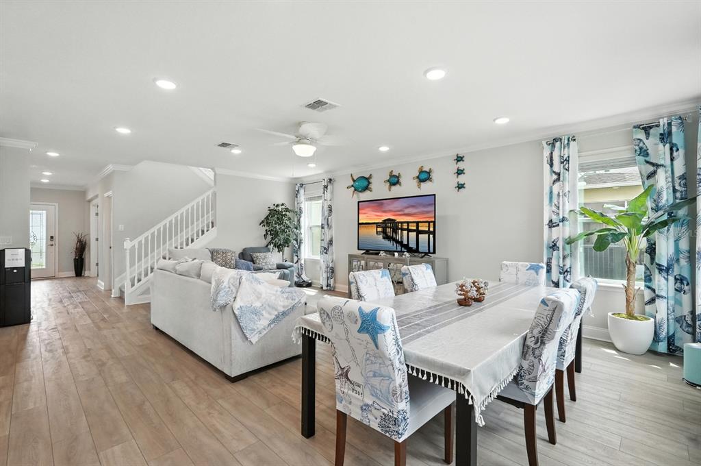 28 Ridge Road Palm Coast, FL 32137 - Photo 9 of 57 a living room with furniture a flat screen tv and a floor to ceiling window