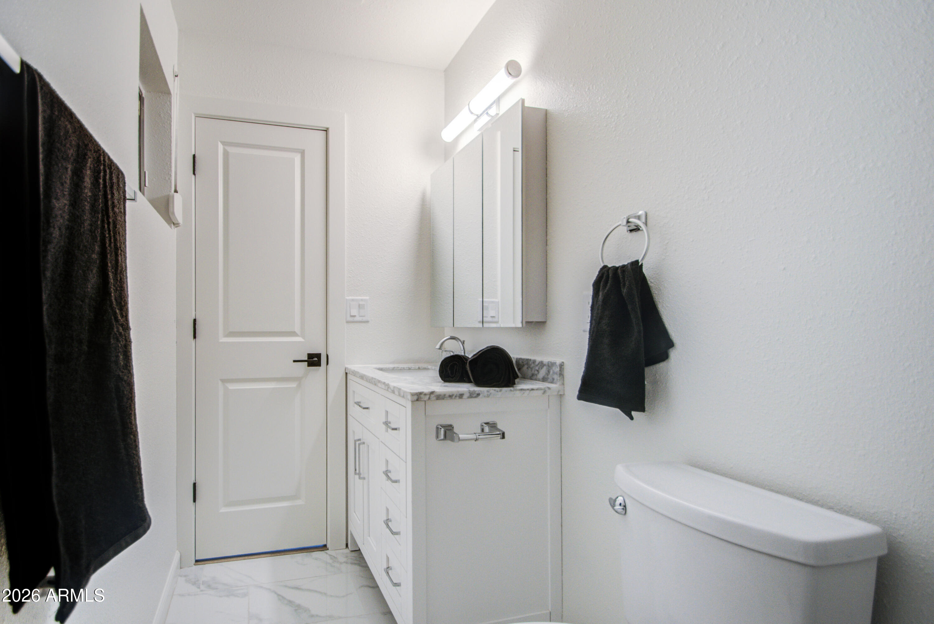 1203 West Elna Rae Street Tempe, AZ 85281 - Photo 28 of 34 a bathroom with a sink a toilet and a shower
