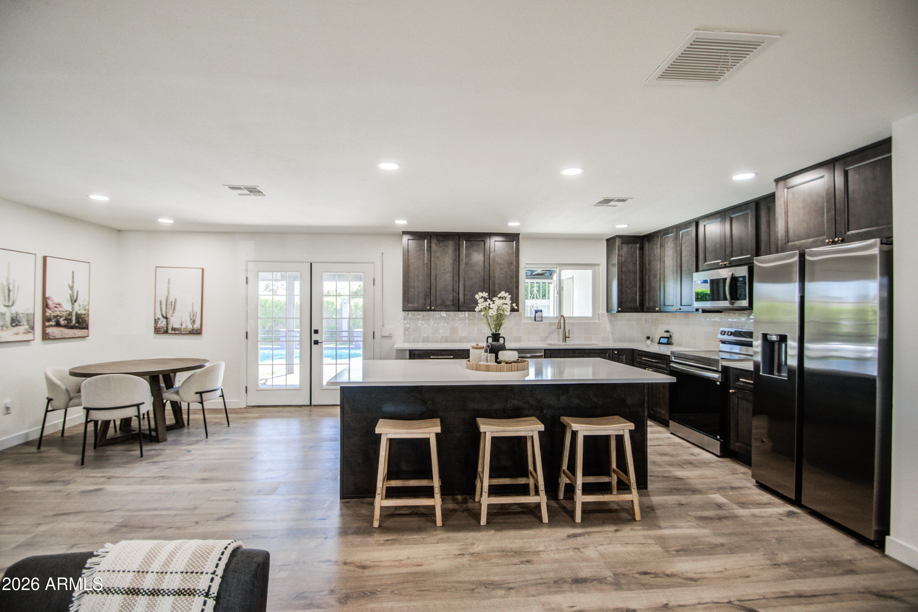 1203 West Elna Rae Street Tempe, AZ 85281 - Photo 6 of 34 a large kitchen with a table and chairs