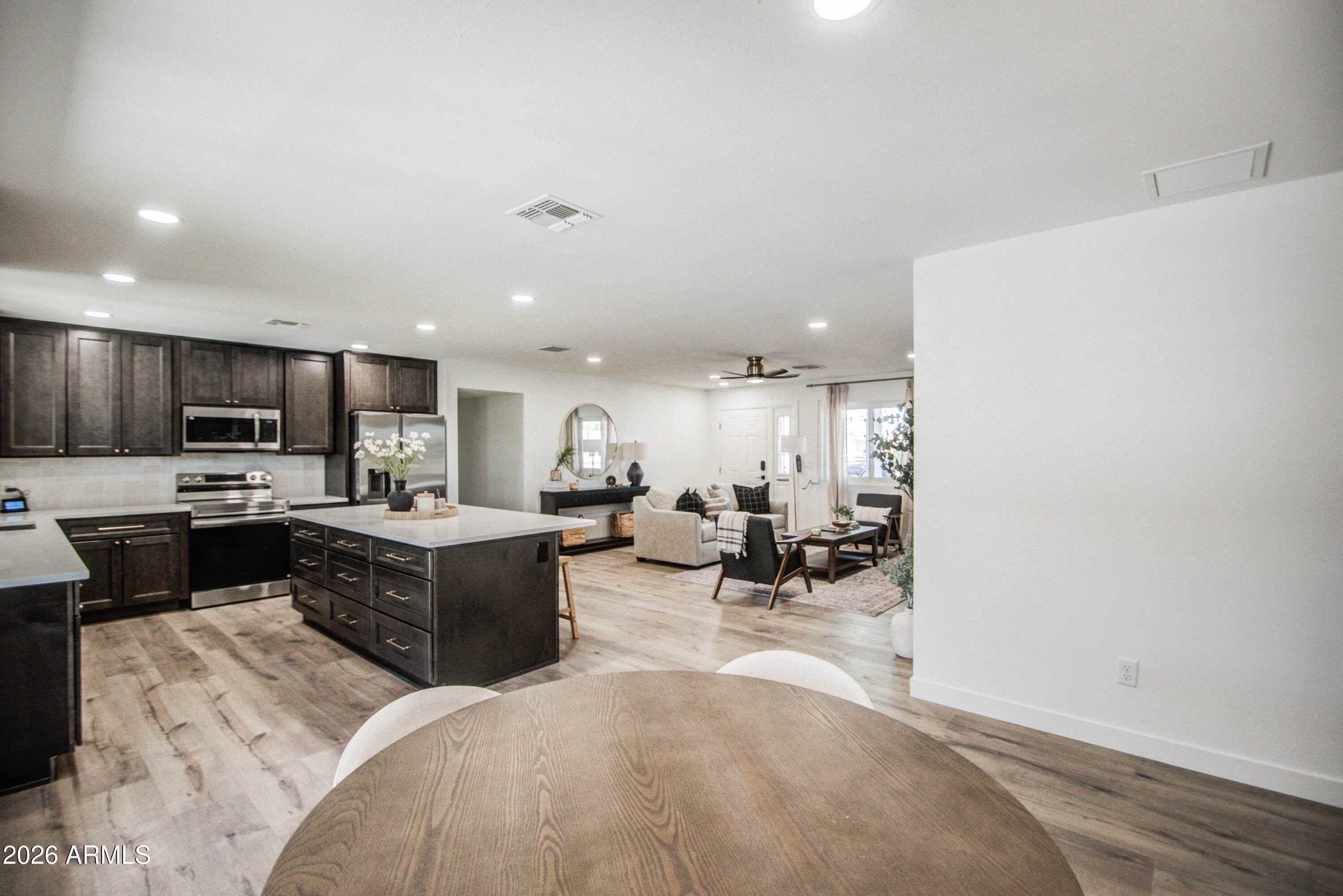 1203 West Elna Rae Street Tempe, AZ 85281 - Photo 8 of 34 a large white kitchen with lots of counter space and stainless steel appliances