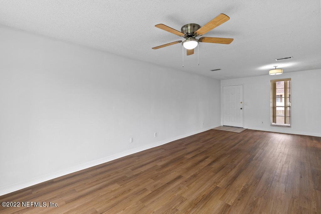 1647 El Camino Road, Unit 5 Jacksonville, FL 32216 - Photo 13 of 44 an empty room with wooden floor and windows