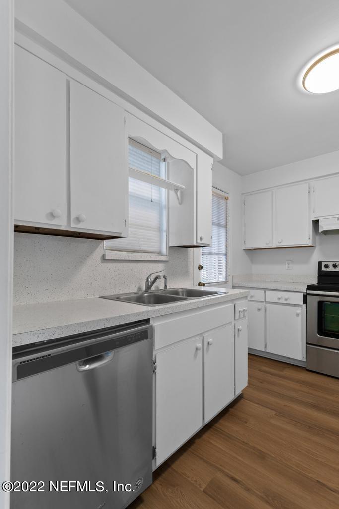 1647 El Camino Road, Unit 5 Jacksonville, FL 32216 - Photo 15 of 44 a kitchen with sink cabinets and wooden floor