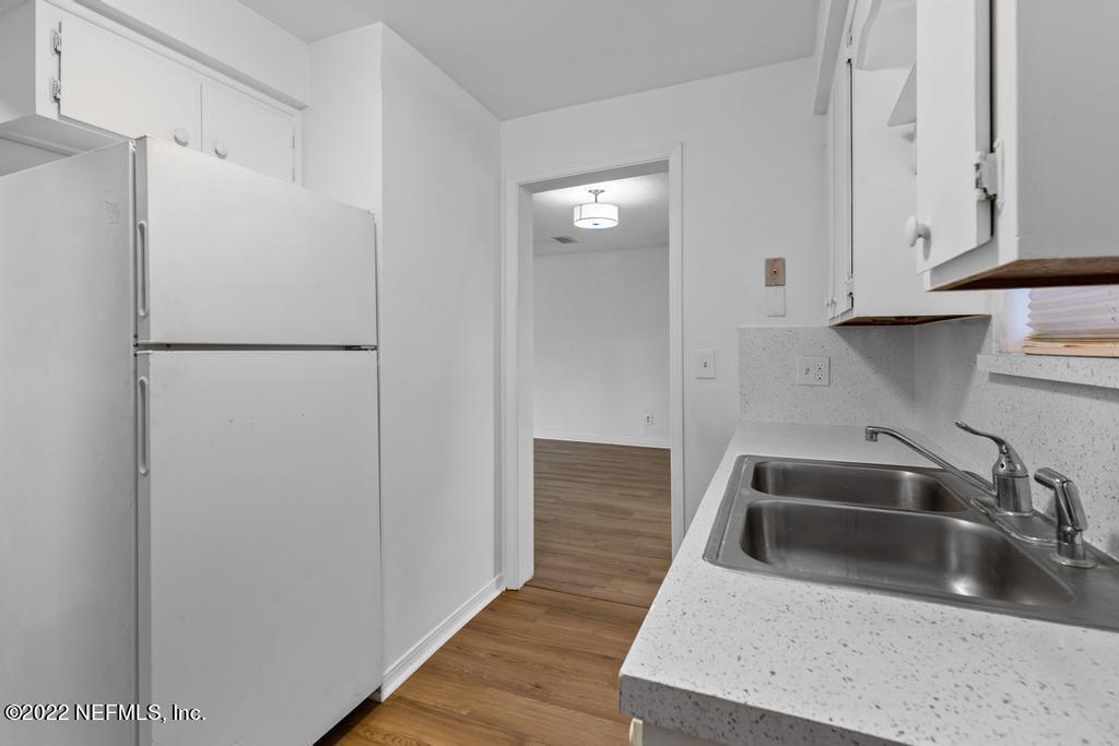 1647 El Camino Road, Unit 5 Jacksonville, FL 32216 - Photo 16 of 44 a kitchen with a sink and refrigerator
