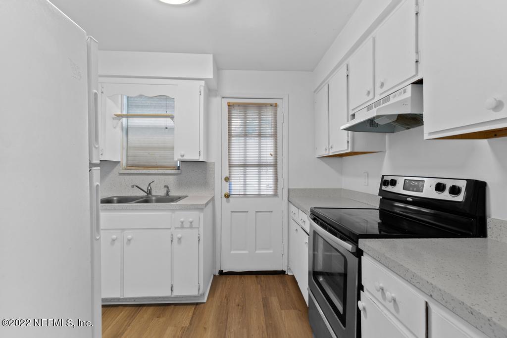1647 El Camino Road, Unit 5 Jacksonville, FL 32216 - Photo 17 of 44 a kitchen with white cabinets and appliances