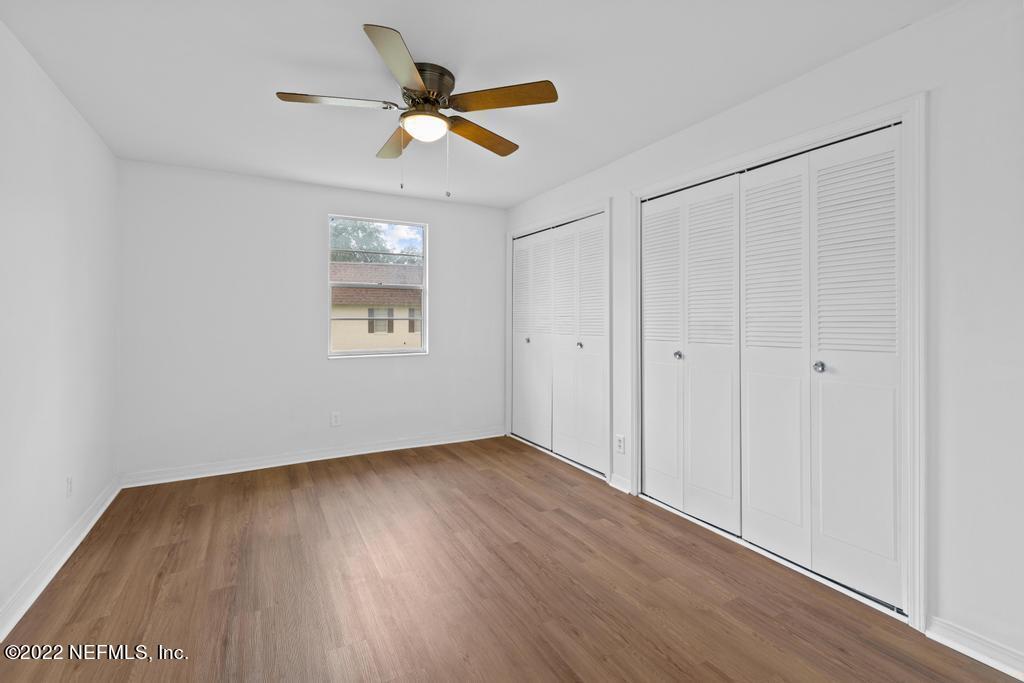 1647 El Camino Road, Unit 5 Jacksonville, FL 32216 - Photo 18 of 44 an empty room with wooden floor and windows