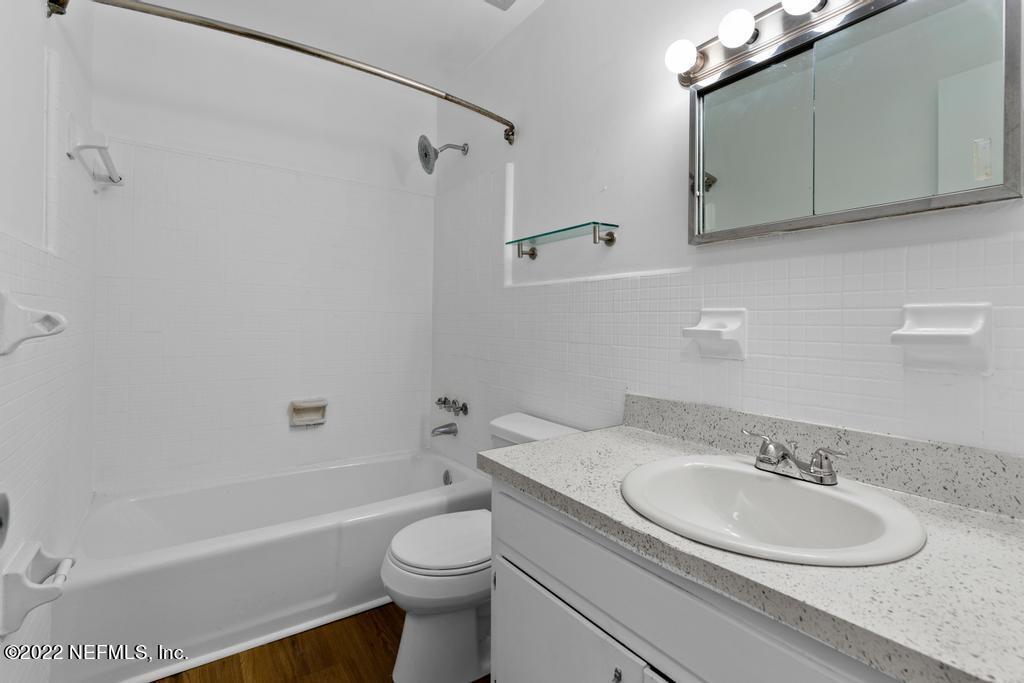 1647 El Camino Road, Unit 5 Jacksonville, FL 32216 - Photo 20 of 44 a bathroom with a granite countertop sink toilet and shower