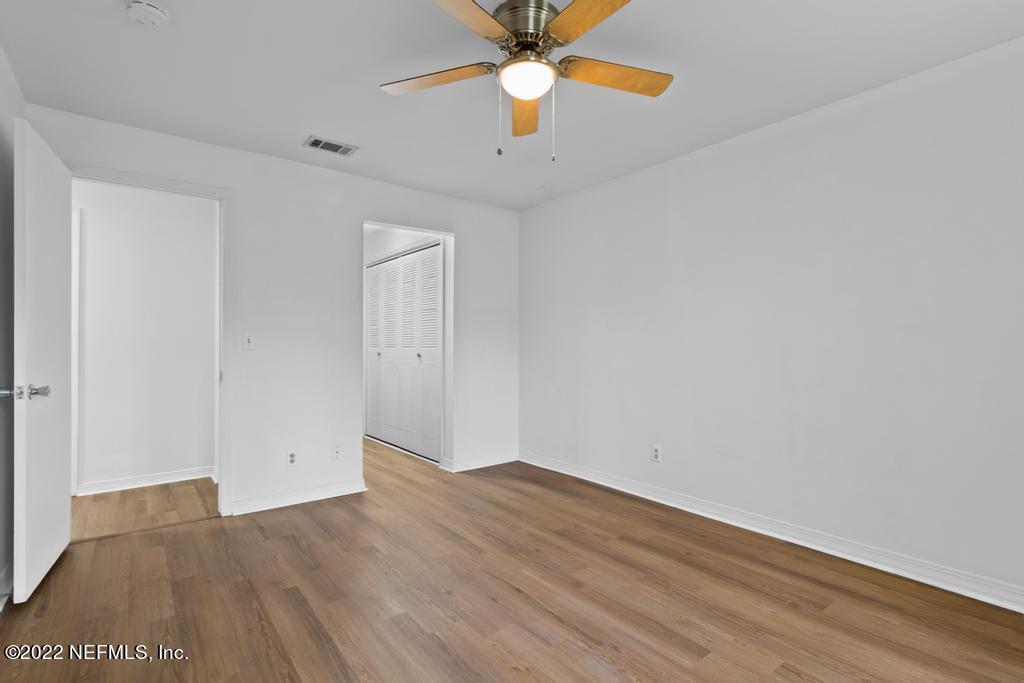 1647 El Camino Road, Unit 5 Jacksonville, FL 32216 - Photo 23 of 44 an empty room with ceiling fan and wooden floor