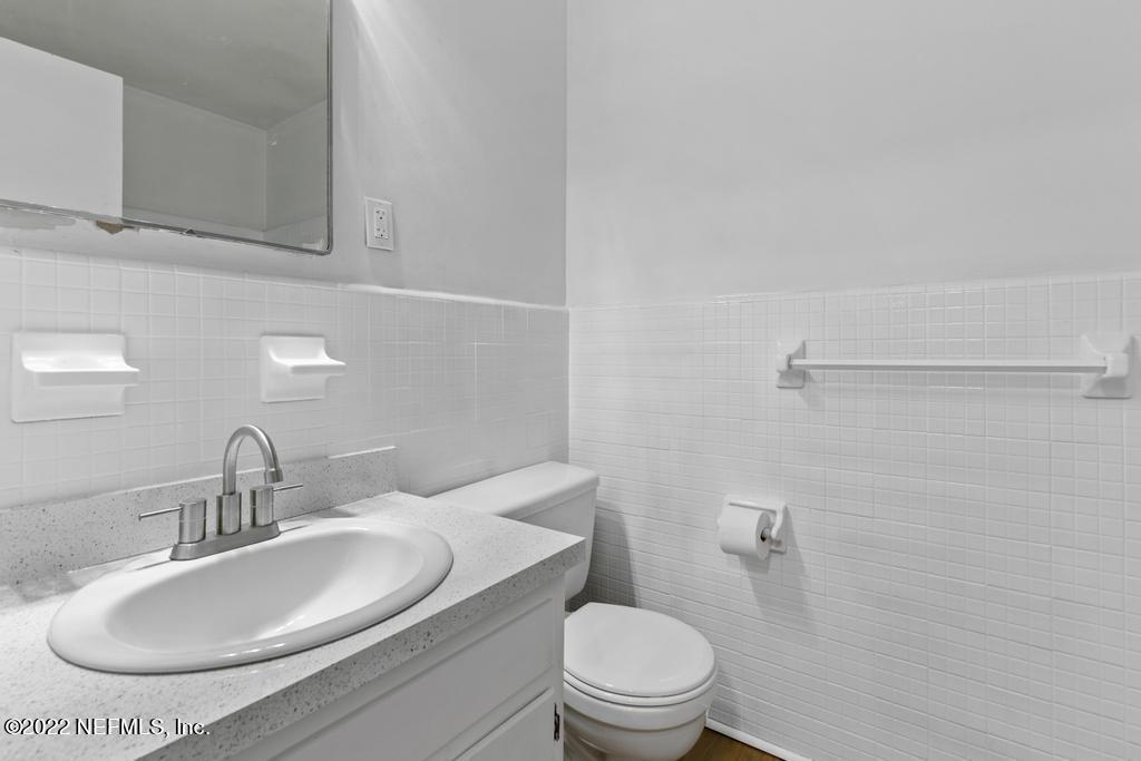 1647 El Camino Road, Unit 5 Jacksonville, FL 32216 - Photo 27 of 44 a bathroom with a toilet sink and mirror
