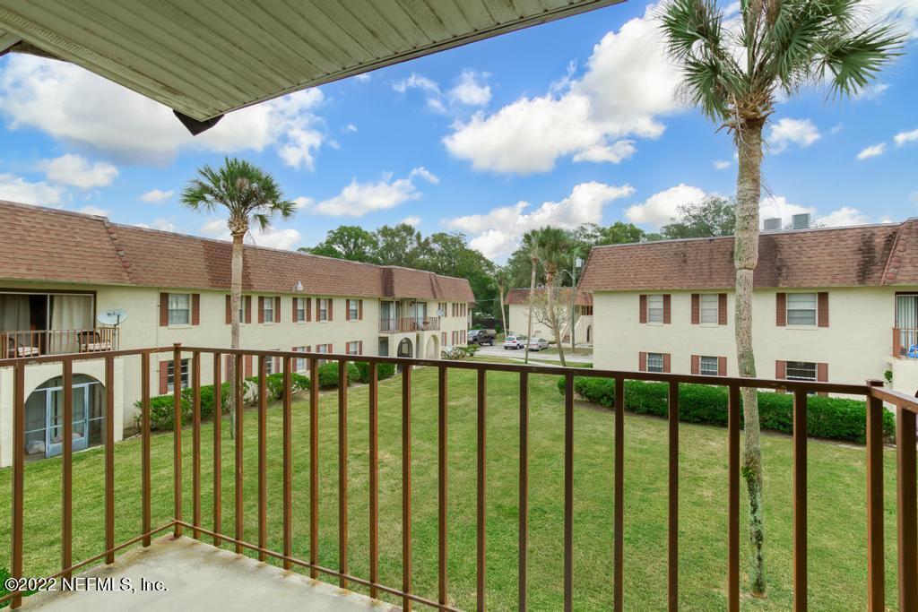 1647 El Camino Road, Unit 5 Jacksonville, FL 32216 - Photo 30 of 44 a view of a house with a wooden deck